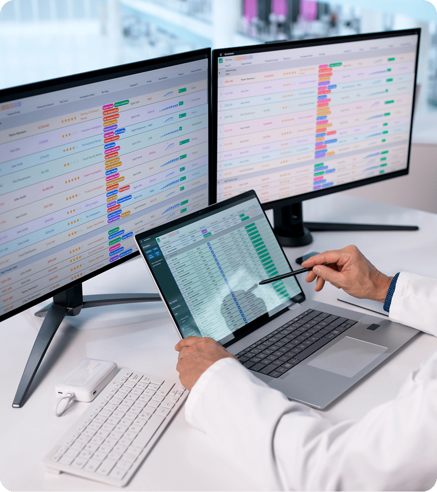 Person reviewing information on computer displays